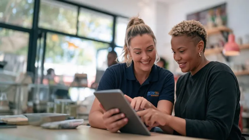 Two colleagues looking at a tablet together